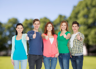 Wall Mural - group of smiling students showing thumbs up
