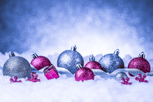 Christmas Ornament In Snow On Glitter Background