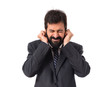 © luismolinero - Businessman covering his ears over white background