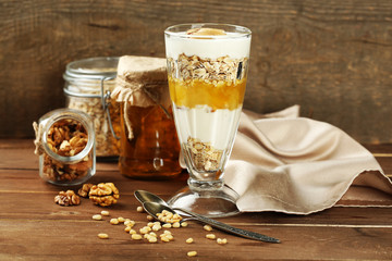 Canvas Print - Tasty dessert with oat flakes and honey, on table