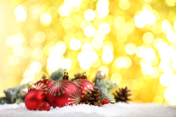 Wall Mural - Christmas balls on snow on bright background