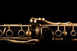 Detail of the clarinet in golden tones on a black background