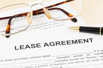 Lease agreement document with glasses and pen