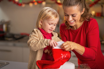 Portrait of happy mother and baby with christmas stocking