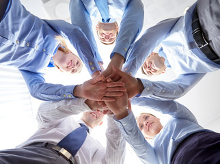 Wall Mural - smiling group of businesspeople standing in circle