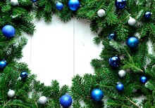 Blue And Silver Christmas Ornament Balls On Fir Leaves