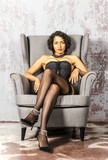 Fototapeta Młodzieżowe - Beautiful young woman in black lingerie and stockings