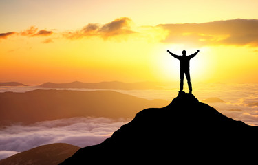Wall Mural - silhouette of a champion on mountain top