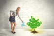 © ra2 studio - Business woman watering a growing green dollar sign tree