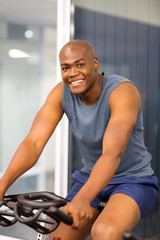 Wall Mural - african american man sitting on a stationary bike