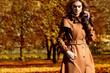© ASjack - Beautiful elegant woman standing in a park in autumn