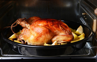 Poster - Delicious baked chicken in oven close-up