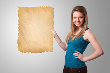 Young girl presenting old paper copy space