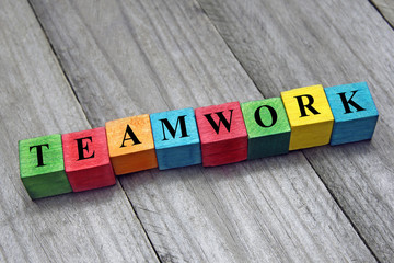 Wall Mural - concept of teamwork word on wooden colorful cubes