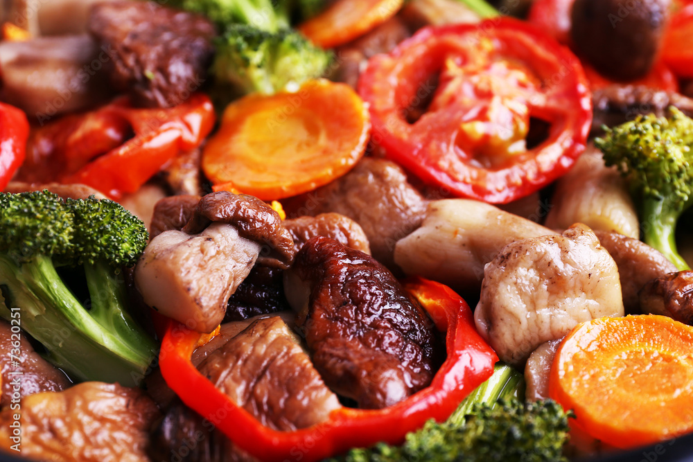 Braised wild mushrooms with vegetables and spices close-up