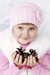 Beautiful young girl holding two cones