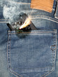 Close up of burning phone in jeans back pocket.