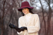 portrait of beautiful girl in hat and leather gloves