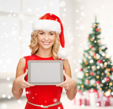 Woman In Santa Helper Hat Showing Tablet Pc Screen