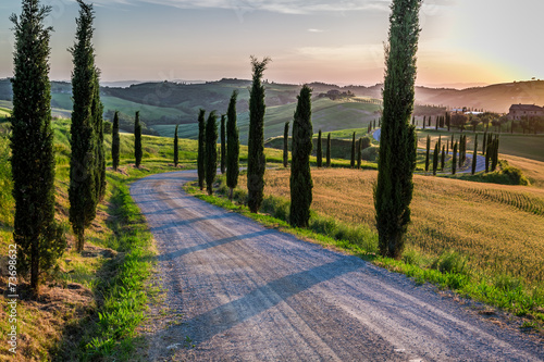 Sunset and winding road wit...