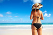 © grinny - Back of Woman in bikini on the beach.