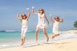 © altanaka - Happy family jumping on the beach on the day time