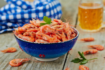 Wall Mural - Prepared shrimp on blue plate on wooden background