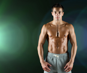 young male bodybuilder with bare muscular torso