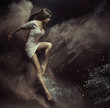 © konradbak - Jumping girl in full of dust place