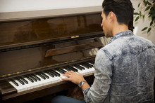 Young Handsome Male Artist Playing Classical Upright Piano
