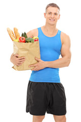 Poster - Young athlete holding a bag full of groceries