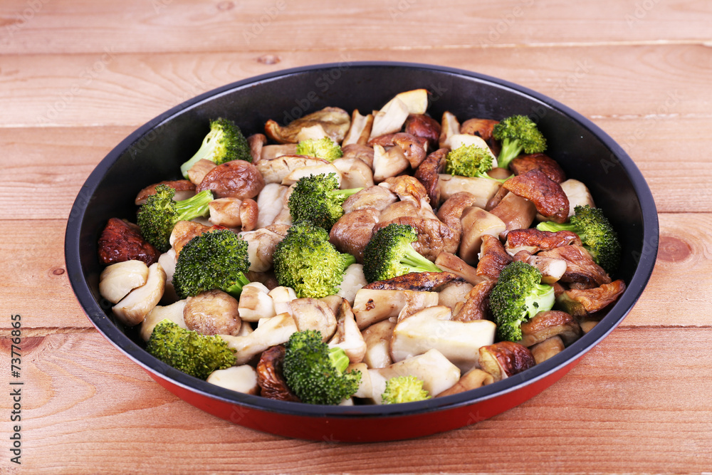 Braised wild mushrooms with vegetables and spices in pan