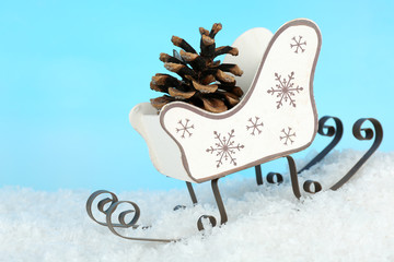 Wall Mural - Christmas decoration in shape sled on light blue background