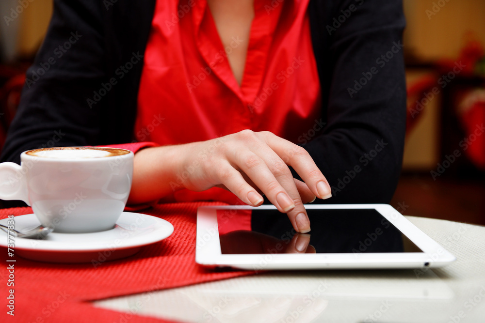 Woman with tablet computer in cafe shop