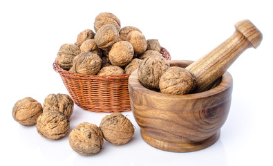 Wall Mural - Walnuts in a basket and a wooden mortar