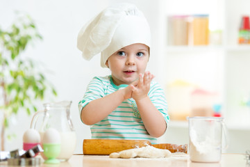 Wall Mural - little baker child girl in chef hat