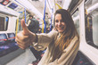 Happy Young Woman Commuting by Tube