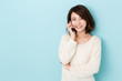 © taka - attractive asian woman talking on blue background