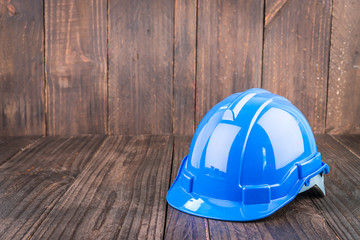 Wall Mural - Construction hard hat on wooden background