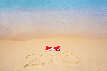 two red santa hats on beach