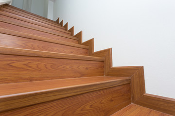 wooden staircase made from laminate wood in white modern house