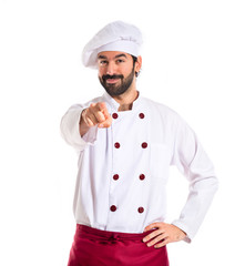 Wall Mural - Chef pointing to the front over white background