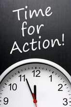 Time For Action Written Above A Clock At Almost Midnight
