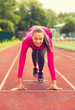 © Syda Productions - smiling young woman running on track outdoors