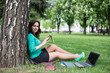 © lexmomot - Young woman reading a book in the city park