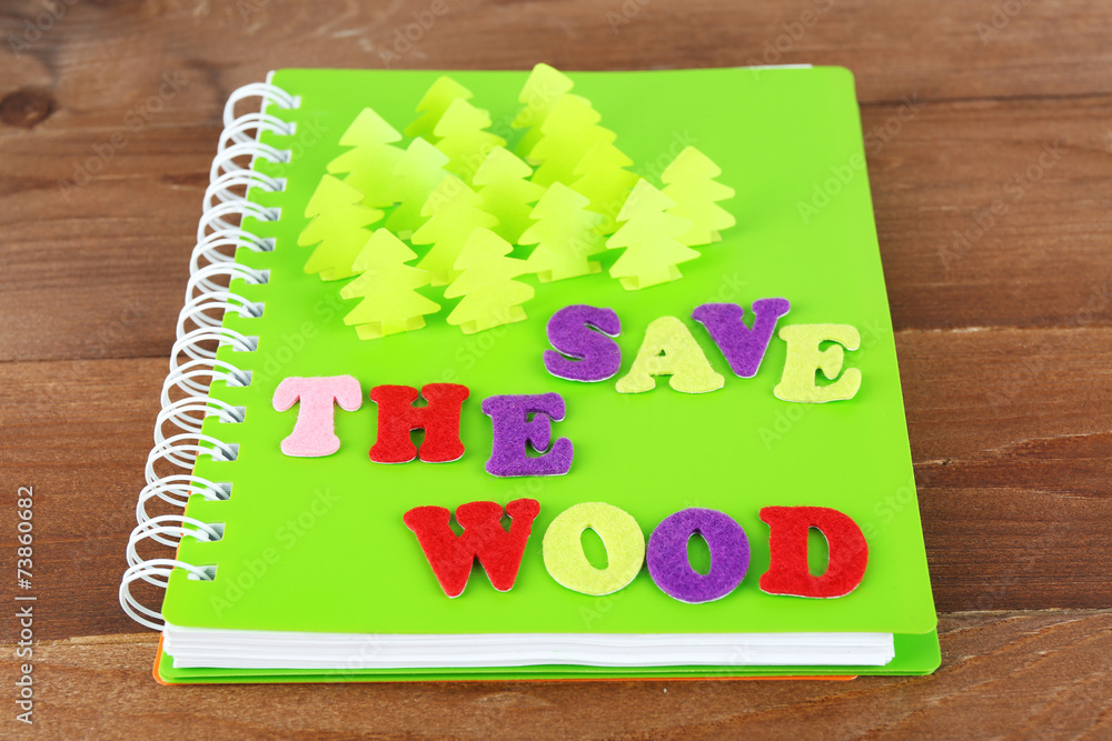 Concept of conservation forests cut paper on notebook