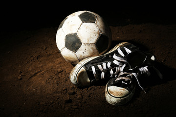 Sticker - Soccer ball on ground on dark background