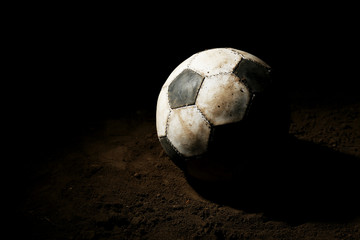 Sticker - Soccer ball on ground on dark background