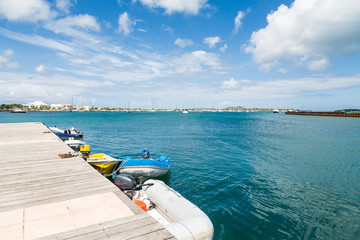 Wall Mural - Small Boats in Azure Water Under Blue Sky