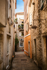  view of old narrow street at sunny day